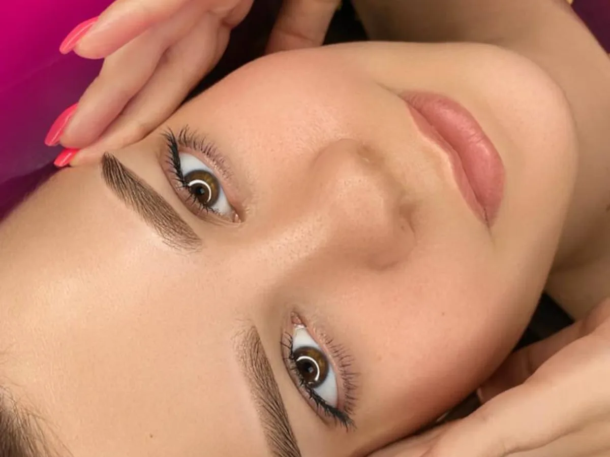 Close-up of a client's brow lamination and tint treatment in progress, editorial beauty photography