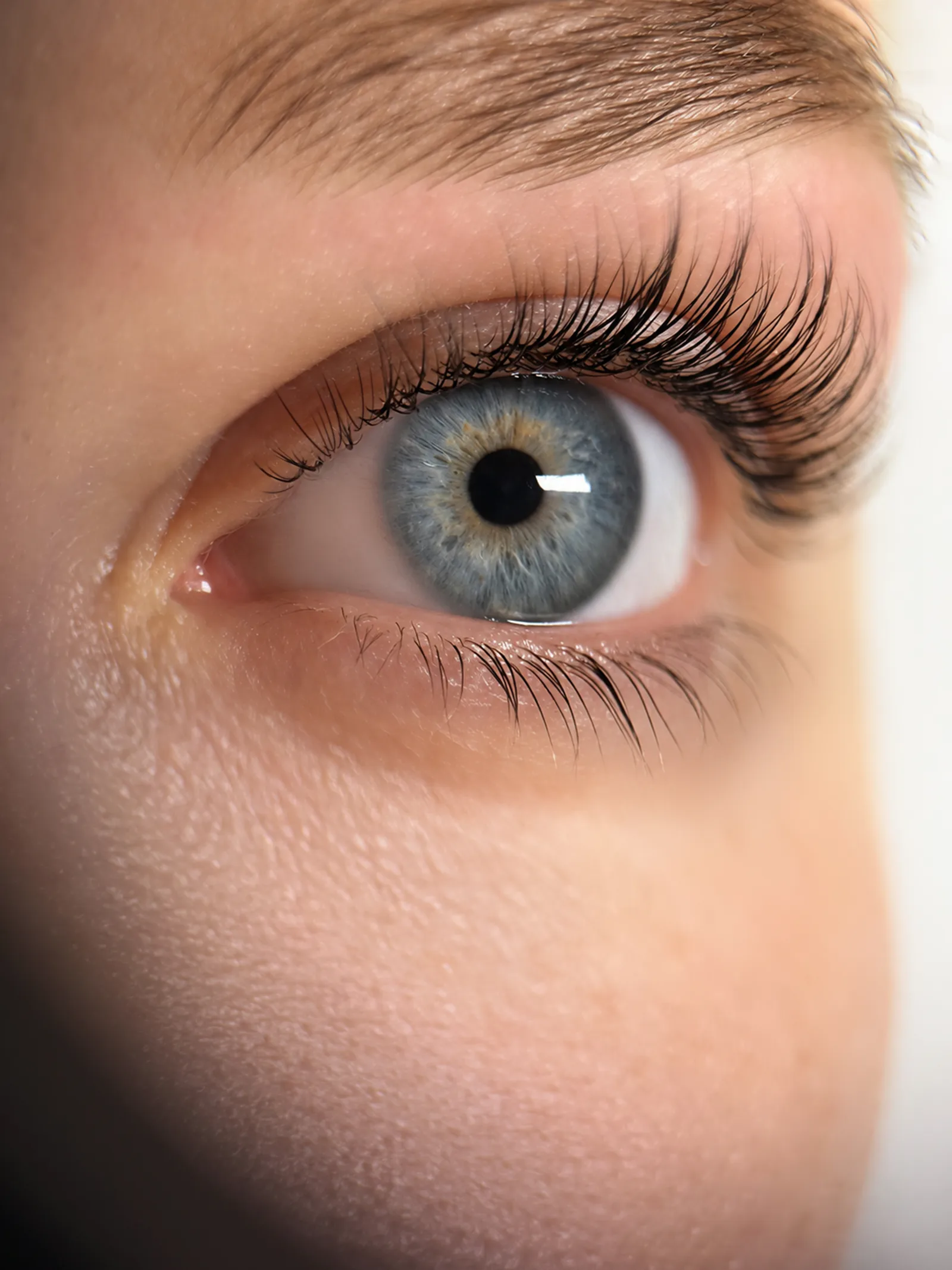 Extreme close-up of a natural classic lash extension set, editorial beauty photography
